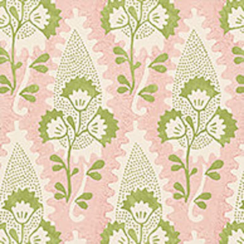 May include: A pink and green paisley fabric with a floral pattern. The fabric features a repeating design of stylized leaves and flowers.