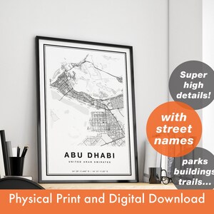May include: A framed black and white map print of Abu Dhabi, United Arab Emirates. The map includes street names, parks, buildings, and trails. The print is labeled "Physical Print and Digital Download."