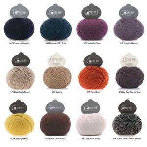 May include: A collection of 18 yarn skeins in various colors, including blue, green, red, purple, brown, and gray. Each skein is labeled with a number and a color name.