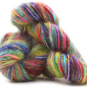 May include: A skein of colorful yarn with a mix of blue, green, red, and purple hues. The yarn is soft and fluffy, and it is perfect for knitting or crocheting.