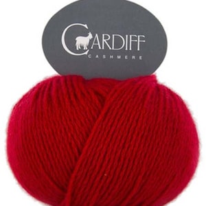 May include: A ball of red cashmere yarn with a label that reads "Cardiff Cashmere" and features a small goat illustration.