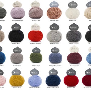 May include: A collection of 24 yarn balls in various colors, including grey, brown, red, blue, green, and yellow. Each ball has a label with the name and number of the yarn color.