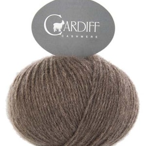 May include: A ball of brown cashmere yarn with a label that reads "CARDIFF CASHMERE" and features a small goat illustration.