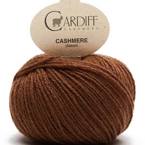 May include: A ball of brown cashmere yarn with a label that reads "CARDIFF CASHMERE CASHMERE classic"