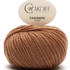 May include: A ball of brown cashmere yarn with a label that reads "CARDIFF CASHMERE CASHMERE classic"