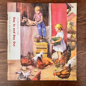 May include: Vintage children's book cover titled "Day in and Day Out." The illustration depicts two children feeding chickens and chicks in a barnyard setting. The cover has a white banner with the book title and "Workbook for The Alice and Jerry Basic Reading Program."