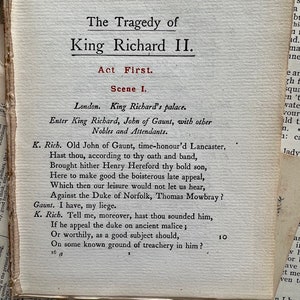 May include: A page from a vintage book of Shakespeare's play, King Richard II. The text is printed in black ink on a cream-colored page. The title of the play is printed in bold, black letters at the top of the page. The text is in a traditional font style.