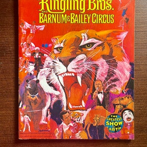 May include: A vintage Ringling Bros. and Barnum & Bailey Circus program cover featuring a roaring tiger with a red background. The text "The Greatest Show on Earth" is in a yellow circle at the bottom right corner.