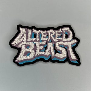 May include: White embroidered patch with the text "ALTERED BEAST" in a 3D style with blue and purple outlines on a black background.