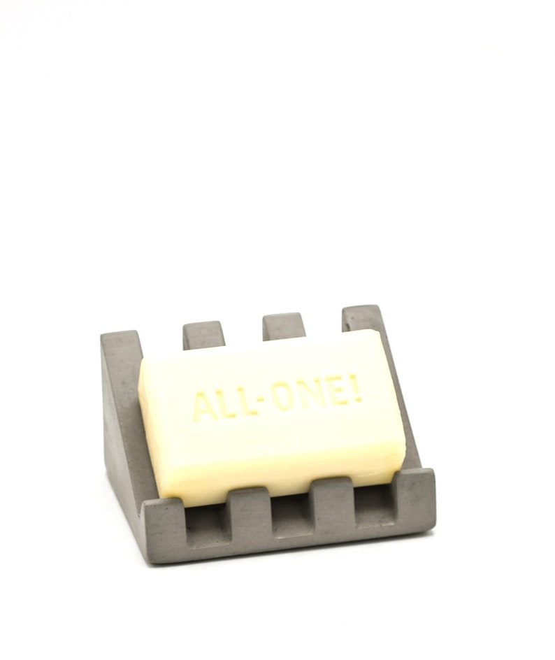 May include: A gray soap dish with a rectangular soap bar that says "ALL-ONE!" on it.