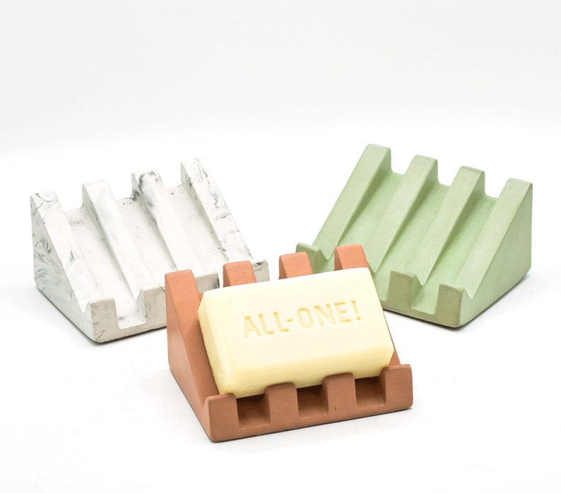 concrete soap dish that holds bar soap on an angle to promote water drainage