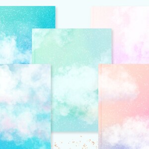 May include: A collection of notebooks with watercolor cloud designs in shades of blue, green, pink, and purple. Each notebook features a different cloud and glitter effect, creating a dreamy and artistic aesthetic. The notebooks are arranged in a visually appealing composition.