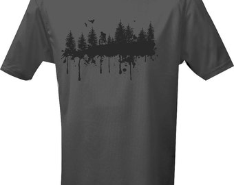 May include: A dark gray t-shirt with a black silhouette of a mountain bike rider in a forest with a splatter paint effect. The text "VULTURE" is printed on the bottom of the shirt.