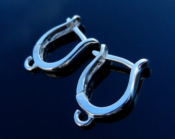 May include: A pair of silver earring hooks, each with a smooth, curved shape and a small loop at the top.