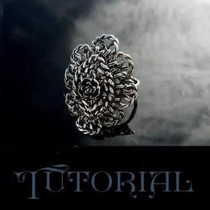 May include: A silver ring featuring an intricate floral design. The ring is crafted from wire that is woven together to form a three-dimensional flower.