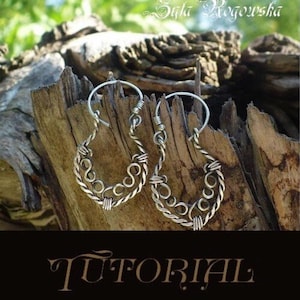 May include: A pair of silver hoop earrings with a twisted wire design. The earrings are handmade and have a unique, intricate pattern.