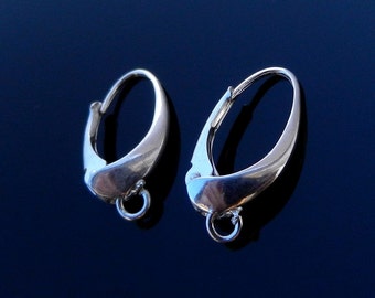 May include: A pair of silver-toned earrings with a curved, teardrop design. Each earring features a hinged lever-back closure and a small, circular loop at the bottom. The earrings are displayed against a dark blue background.