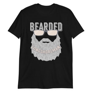Puede incluir: Camiseta negra con un gráfico blanco de una cara barbuda con gafas de sol y el texto "Bearded Longshoreman".