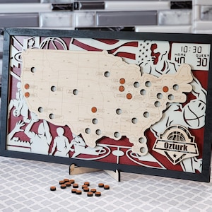 May include: Wooden basketball-themed wall art featuring a map of the United States with basketball-related imagery. The artwork includes a black frame, a red and white background, and the word "Ozturk". The score is 40-30.