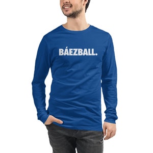 May include: A royal blue long-sleeve t-shirt with the text "B&Aacute;EZBALL." printed in white on the front.