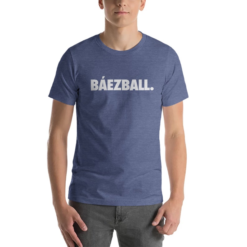 May include: A blue heather t-shirt with white text that reads "B&Aacute;EZBALL."