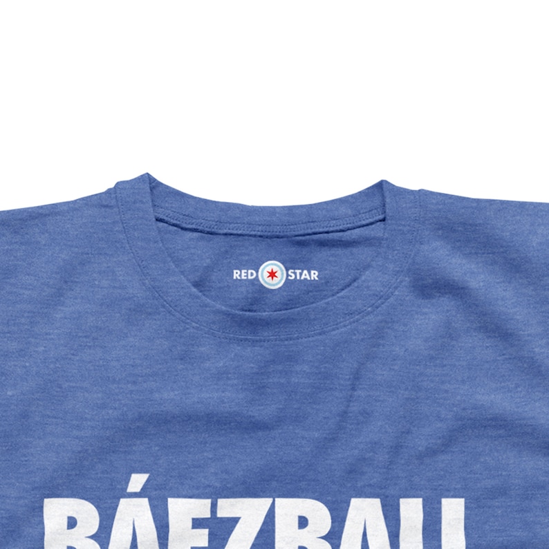May include: A royal blue t-shirt with the text "B&Aacute;EZBALL" in white letters. The shirt has a red star logo with the text "RED STAR" on the neck.