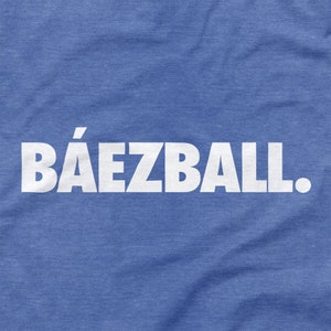 May include: A blue t-shirt with the text "B&Aacute;EZBALL." printed in white.