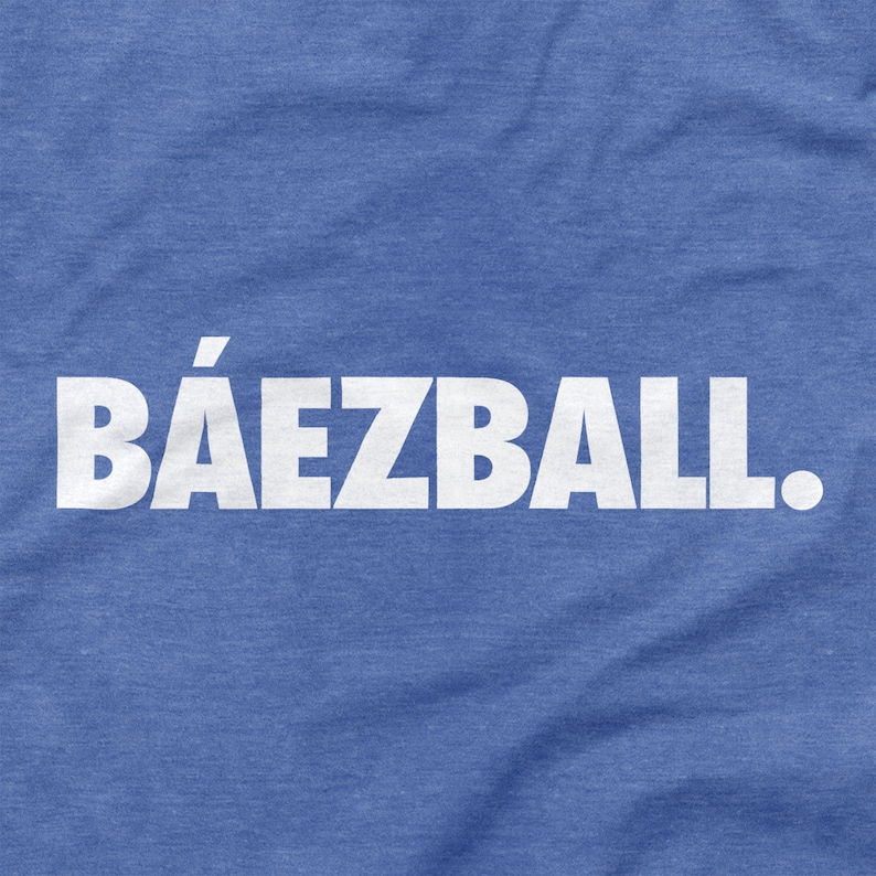 May include: A blue t-shirt with the text "B&Aacute;EZBALL." printed in white.