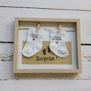 Personalized pregnancy announcement frame with baby socks
