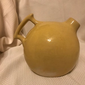 CAMARK pottery ball water pitcher, pale yellow, c1930