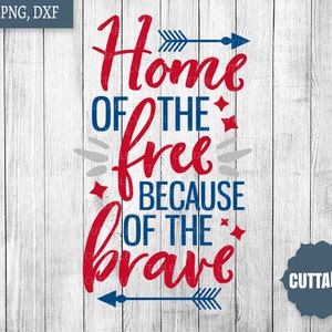 May include: Red, white, and blue graphic with the text "Home of the free because of the brave" with arrows on either side. The graphic is on a white wood background.