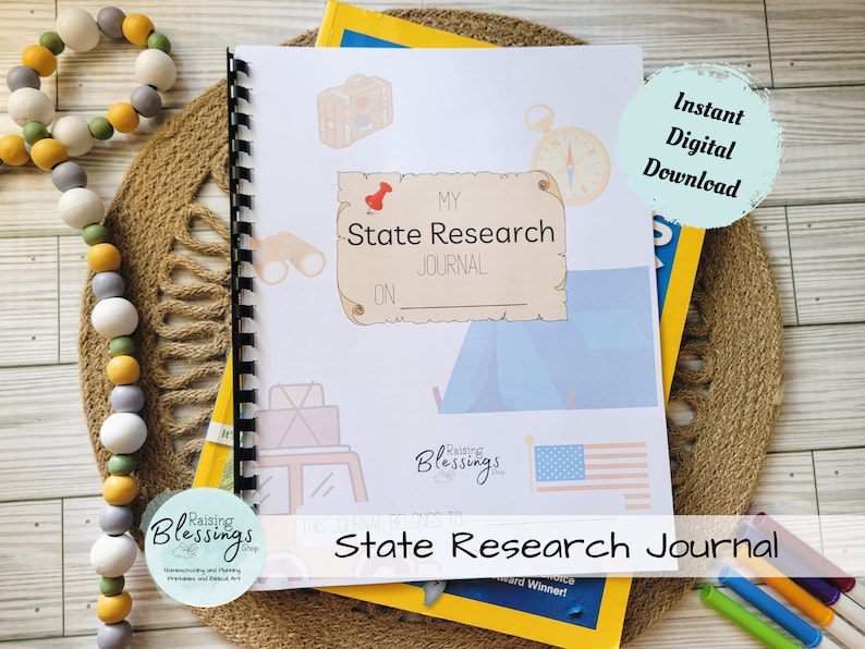May include: A printable state research journal featuring a blue and white tent, compass, binoculars, and a red bird on the cover. The journal is titled "My State Research Journal" and has a space to write the name of the state. The journal is designed for children to learn about different states.