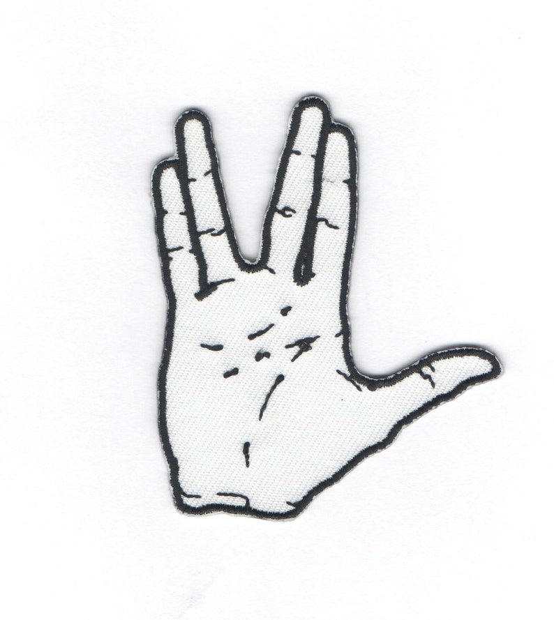 May include: A black and white embroidered patch of a hand making the Vulcan salute, a popular symbol from the Star Trek franchise.