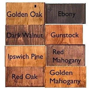 May include: Wood stain color samples in various shades of brown, red, and black. The samples are labeled with the following names: Golden Oak, Ebony, Dark Walnut, Gunstock, Ipswich Pine, Red Mahogany, Red Oak, and Golden Mahogany.