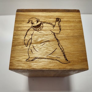 May include: A wooden box with a laser-engraved image of the character Jack Skellington from the movie The Nightmare Before Christmas.