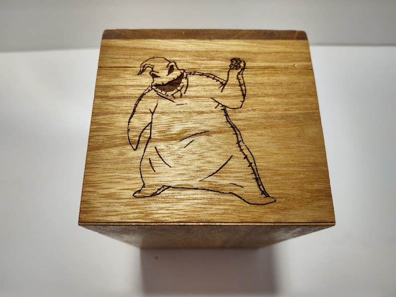 May include: A wooden box with a laser-engraved image of the character Jack Skellington from the movie The Nightmare Before Christmas.