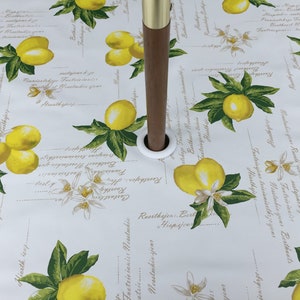 May include: White tablecloth with a lemon print. The tablecloth features a repeating pattern of lemons, leaves, and flowers. The text "Bertheast Neustakin" is repeated throughout the tablecloth.