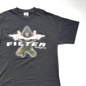 May include: Black t-shirt with a white graphic of a man in a hooded sweatshirt with the word "FILTER" and the text "*amalgamut*" below.