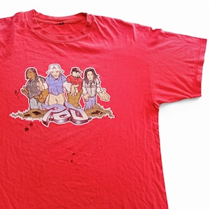 May include: Red band t-shirt with a cartoon image of four people in front of the word "RED".