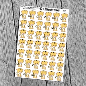 May include: Sheet of stickers featuring cartoon tigers with yellow and black stripes. Each tiger has a smiling face and is in a standing pose. The stickers are on a white background with the text "Dallingtons" and "307".