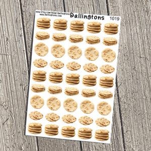 May include: Sheet of stickers featuring stacks and single pieces of round, light brown crackers. The stickers are on a white background with the text "Dallingtons" and a product number. The stickers are arranged on a white sheet.