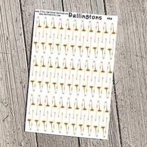 May include: A sheet of white sticker paper with a repeating pattern of gold trombone illustrations. The text "Dallingtons 459" is printed in the top right corner.