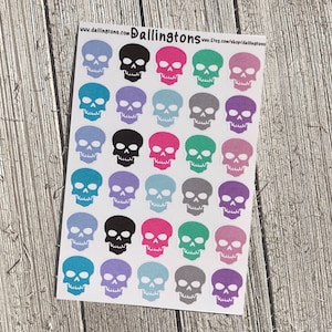Puede incluir: Una hoja de pegatinas de calaveras de colores. Las calaveras son de varios colores, incluyendo rosa, azul, verde, morado y gris. Las calaveras son todas del mismo tamaño y forma, y están dispuestas en una cuadrícula.