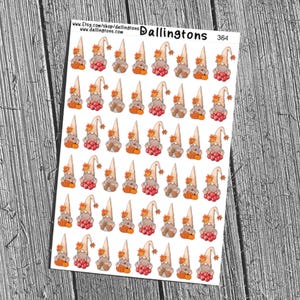 May include: Sheet of stickers featuring autumn gnomes. Each gnome has a tall, cream-coloured hat with a leaf, a brown body, a red berry beard, and an orange pumpkin. The sheet is labelled "Dallington's 364".