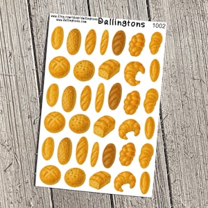 May include: A sheet of stickers featuring various baked goods, including loaves of bread, rolls, and croissants. The stickers are in shades of brown and yellow, with details like textures and shadows. The sheet has the text "Dallingtons 1002".