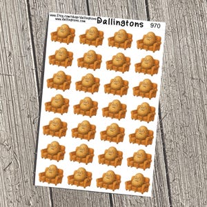 May include: Sheet of stickers featuring a cartoon potato character sitting on a small orange couch. The stickers have a white background and the text "Dallingtons" and "970" is visible. The stickers are on a wooden surface.