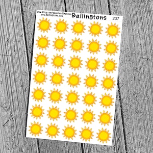 May include: Sheet of stickers featuring a repeating pattern of yellow suns with orange rays on a white background. The stickers are arranged on a rectangular sheet with the text "Dallington's" and "237" printed on the top.