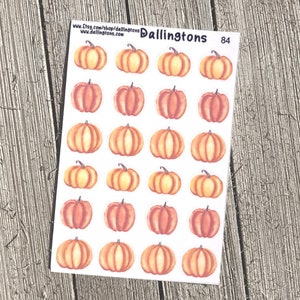 Puede incluir: Una hoja de 24 pegatinas de calabaza de acuarela. Las calabazas son de varios tonos de naranja y marrón. Las pegatinas están sobre un fondo blanco. El texto "Dallingtons 84" está en la esquina superior derecha.