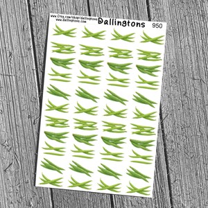 May include: Sheet of stickers featuring green bean illustrations. The stickers are arranged in rows and columns on a white background. The sheet includes the text "Dallington's" and "950". The stickers are on a wooden surface.