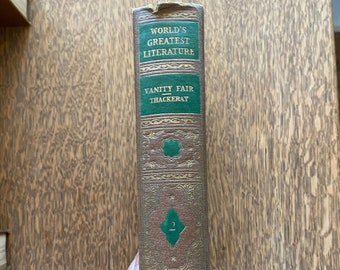 May include: A brown hardcover book spine with green panels featuring gold embossed text that reads World's Greatest Literature, Vanity Fair, Thackeray, and the number 2. The spine is decorated with intricate gold filigree patterns.